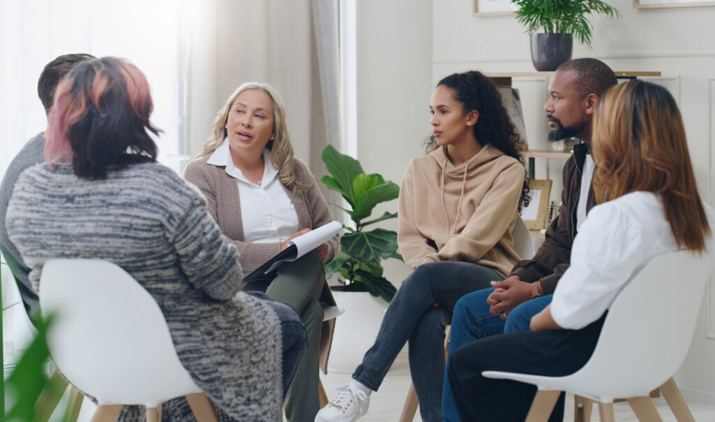 A group of employees discussing their mental health at work.