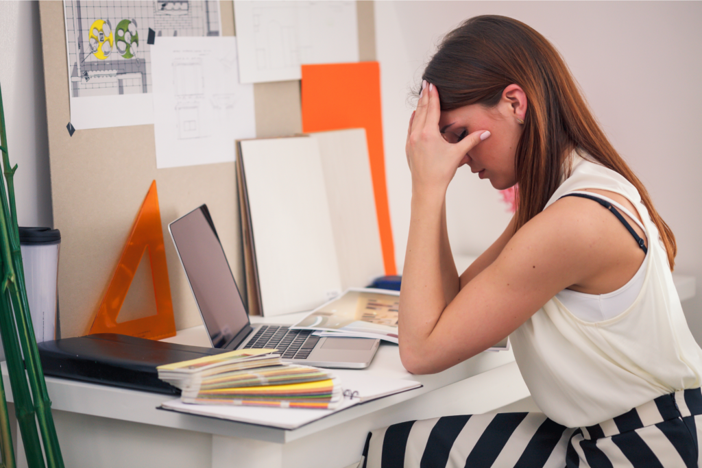 A photograph of a woman experiencing burnout at work.