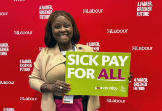 A photograph of a self-employed Community Trade Union member holding a placard for the We Are The UK Self-Employed campaign that reads "Sick Pay For All".