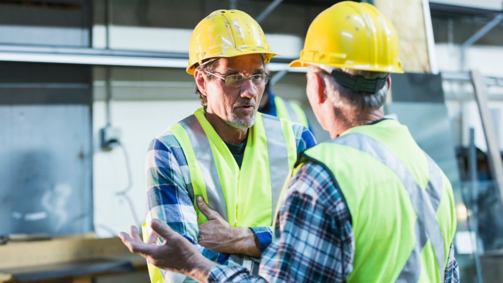 Community Union members having a one-to-one conversation around workplace issues to tie into mapping the workplace.